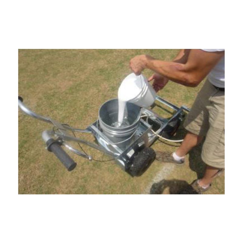 Striping soccer field with field marking paint.