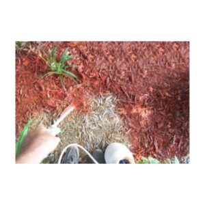 Garden Bed With Red Mulch And Green Plants Along Lawn Edge