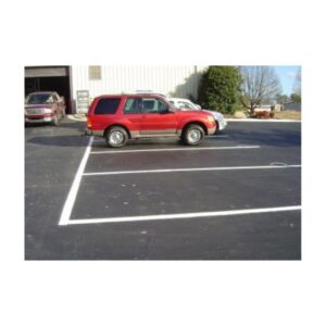 Commercial Parking Lot With New Striping Near Red Car