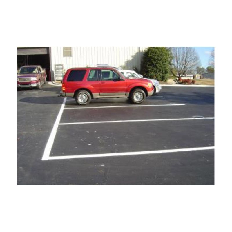 Commercial Parking Lot With New Striping Near Red Car