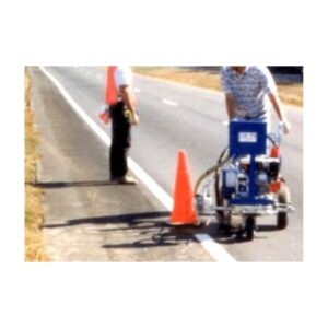 Worker Operating A Road Painting Machine With Traffic Cones