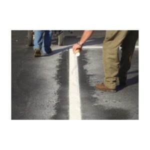 Person Applying White Line Marking Paint To Pavement Surface
