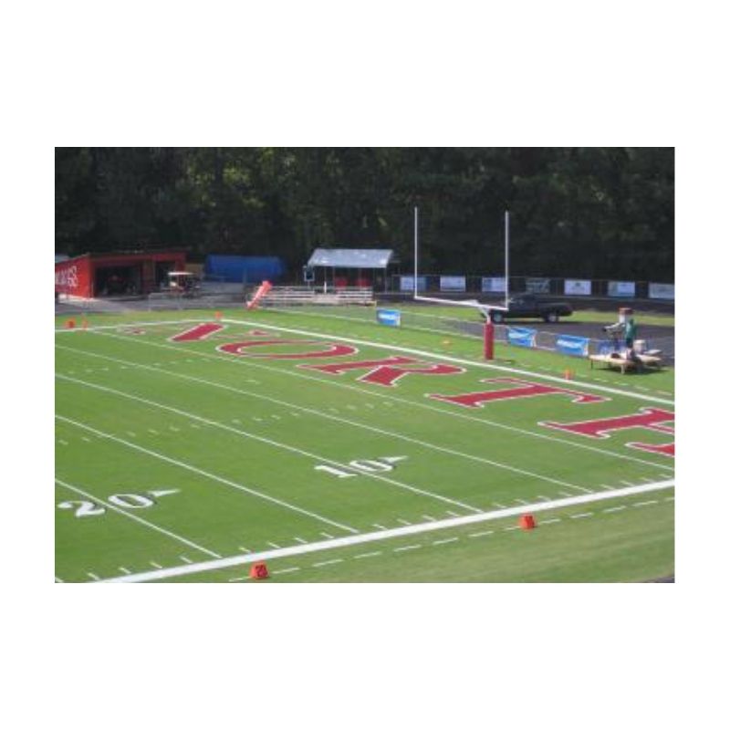 Football end zone painting bright red bright white grass field paint.