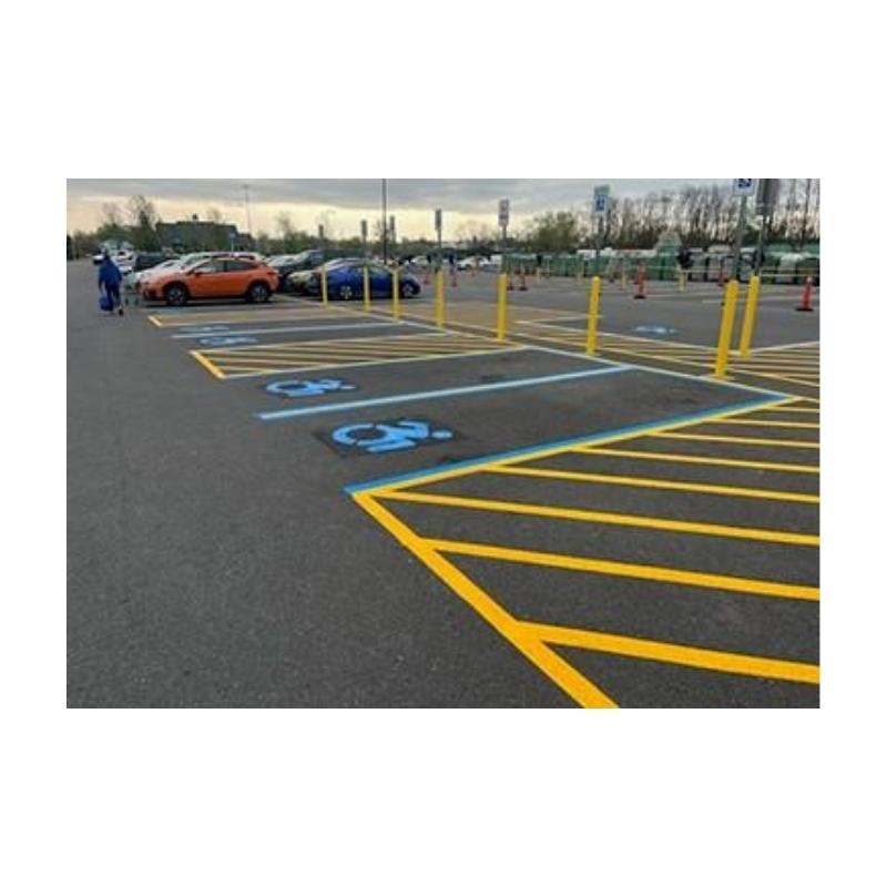 Painting Handicap Parking Lot With Instant Dry Blue Traffic Paint.