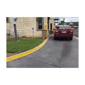 Car Parked On A Paved Surface With Yellow Curbs