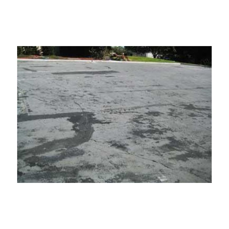 Damaged Asphalt Driveway With Wide Deep Cracks.