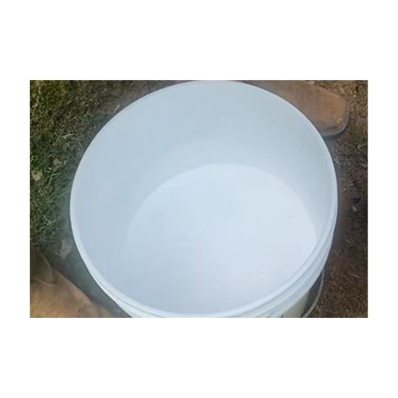 White Liquid Inside A Bucket On Grass