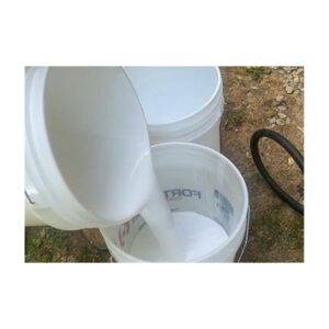 White Liquid Being Poured Into A Bucket Outdoors