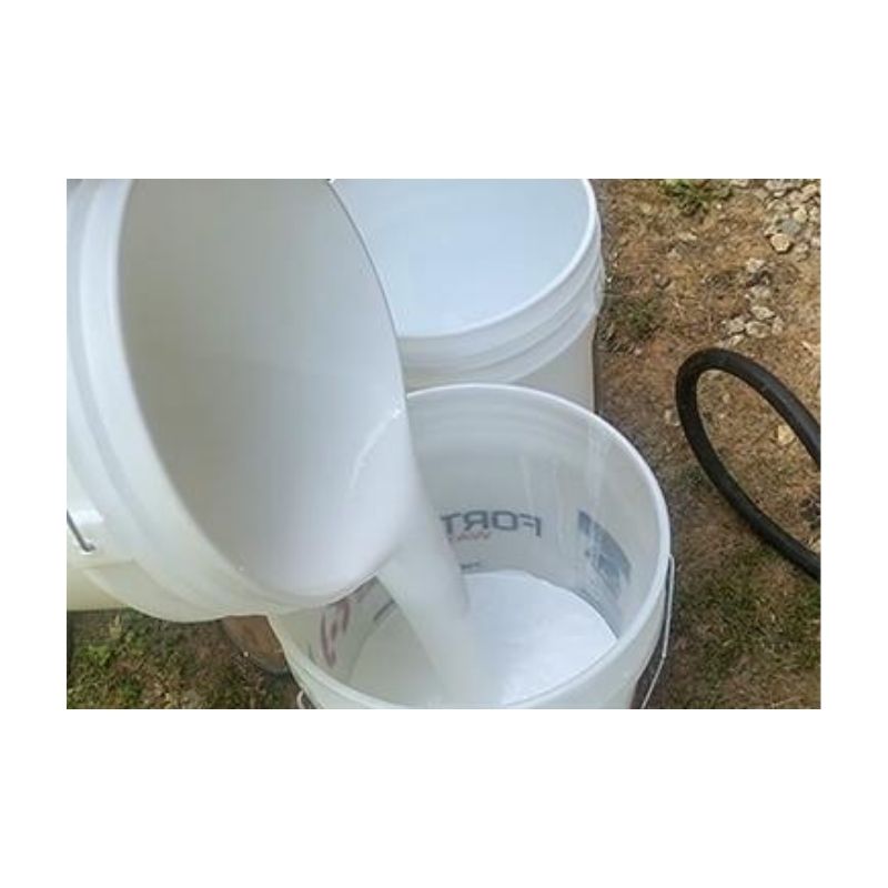 White Liquid Being Poured Into A Bucket Outdoors