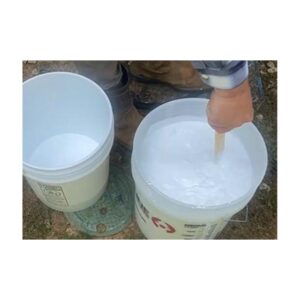 White Paint Being Poured Into Bucket Outdoors