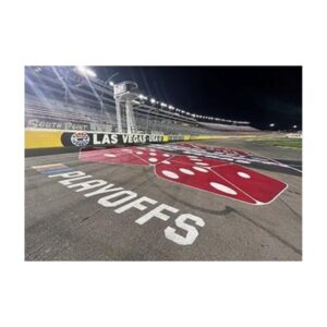 Race Track With Red And White Painted Playoffs Logo At Night