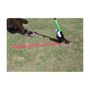 Person Using Long-Handled Wand To Apply Pink Utility Marking Paint On Grass